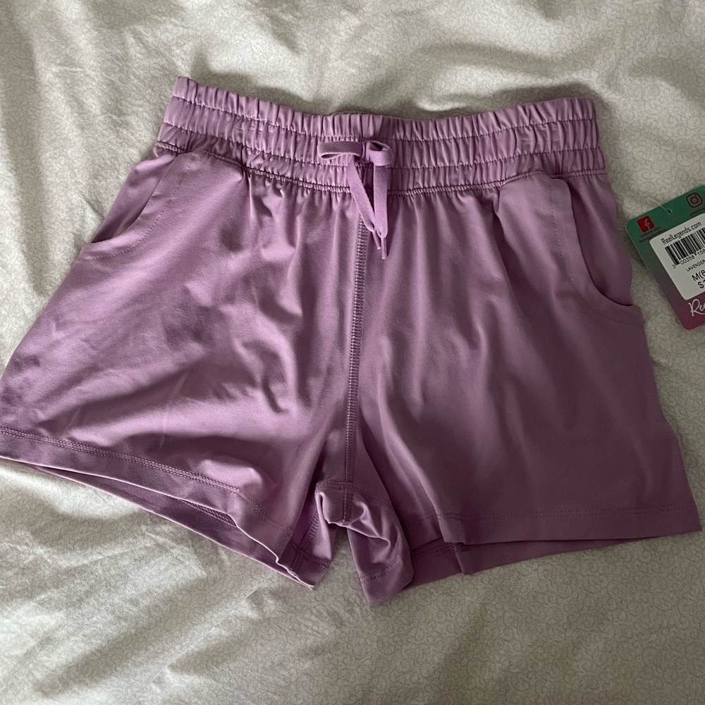 NWT. Reel Legends girls lavender shorts. M8/10. 88%poly, 12%spandex, 12”length